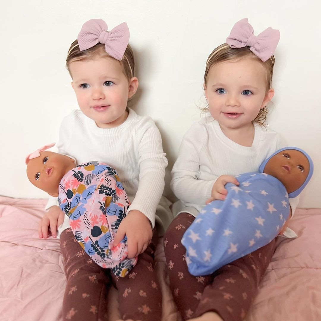 twin girls with LullaBaby twin dolls