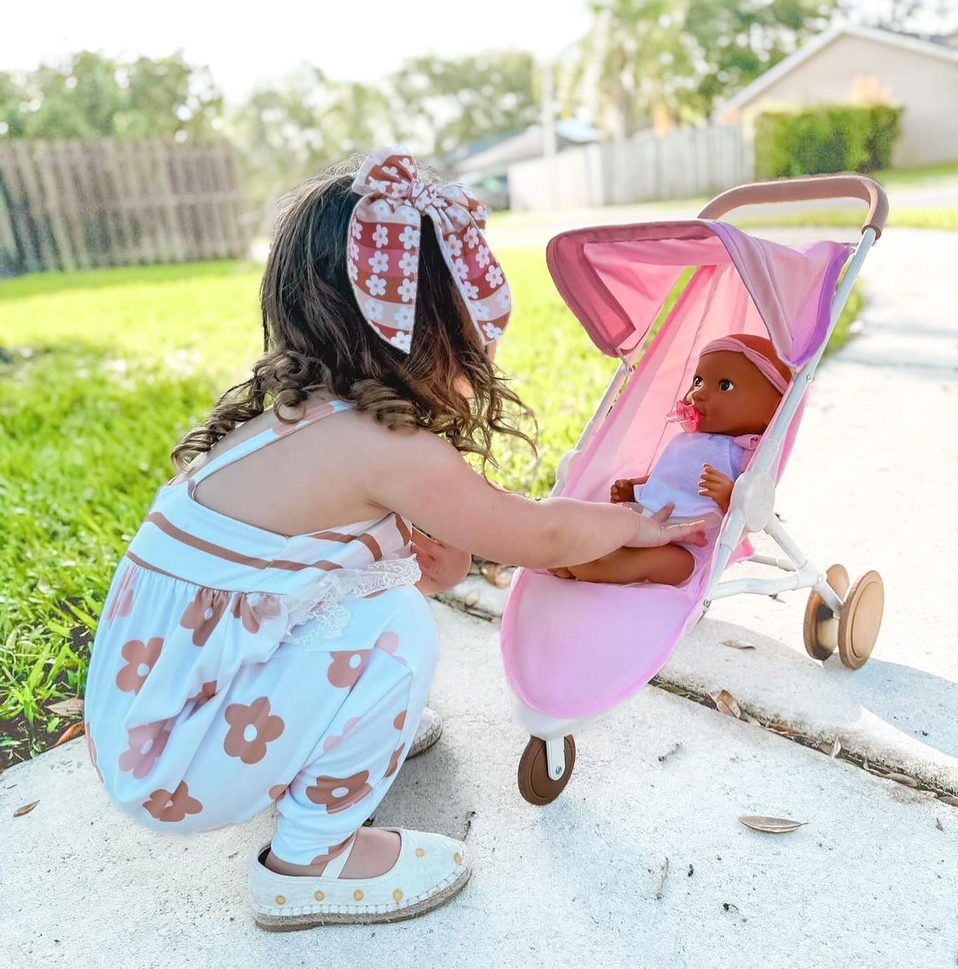 Benefits of Dolls for Children, girl playing with LullaBaby baby doll outside