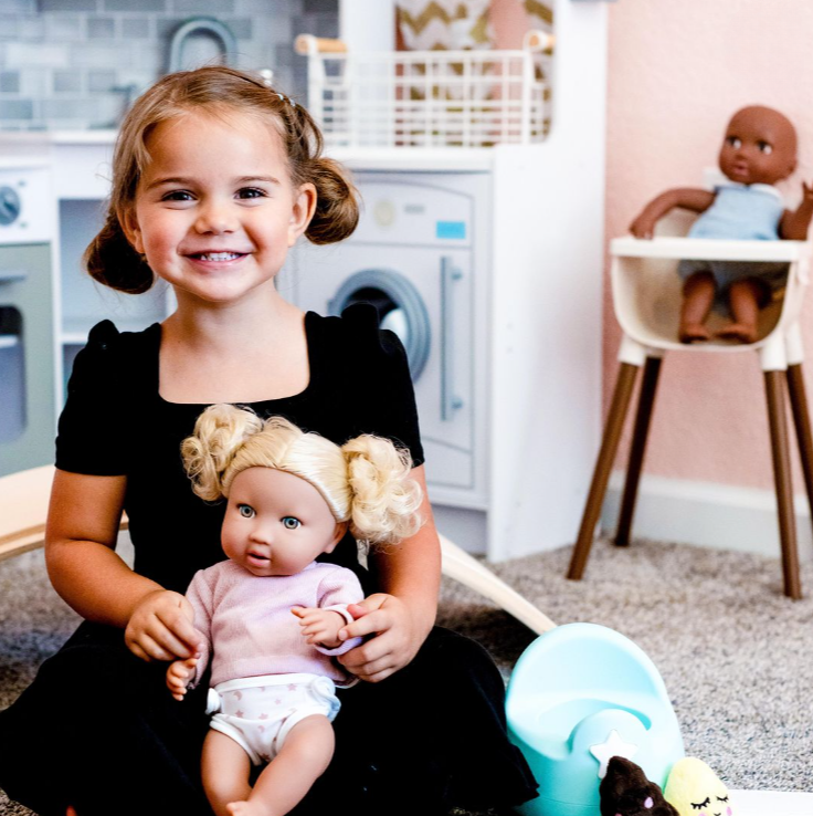 Girl with LullaBaby doll and potty toy