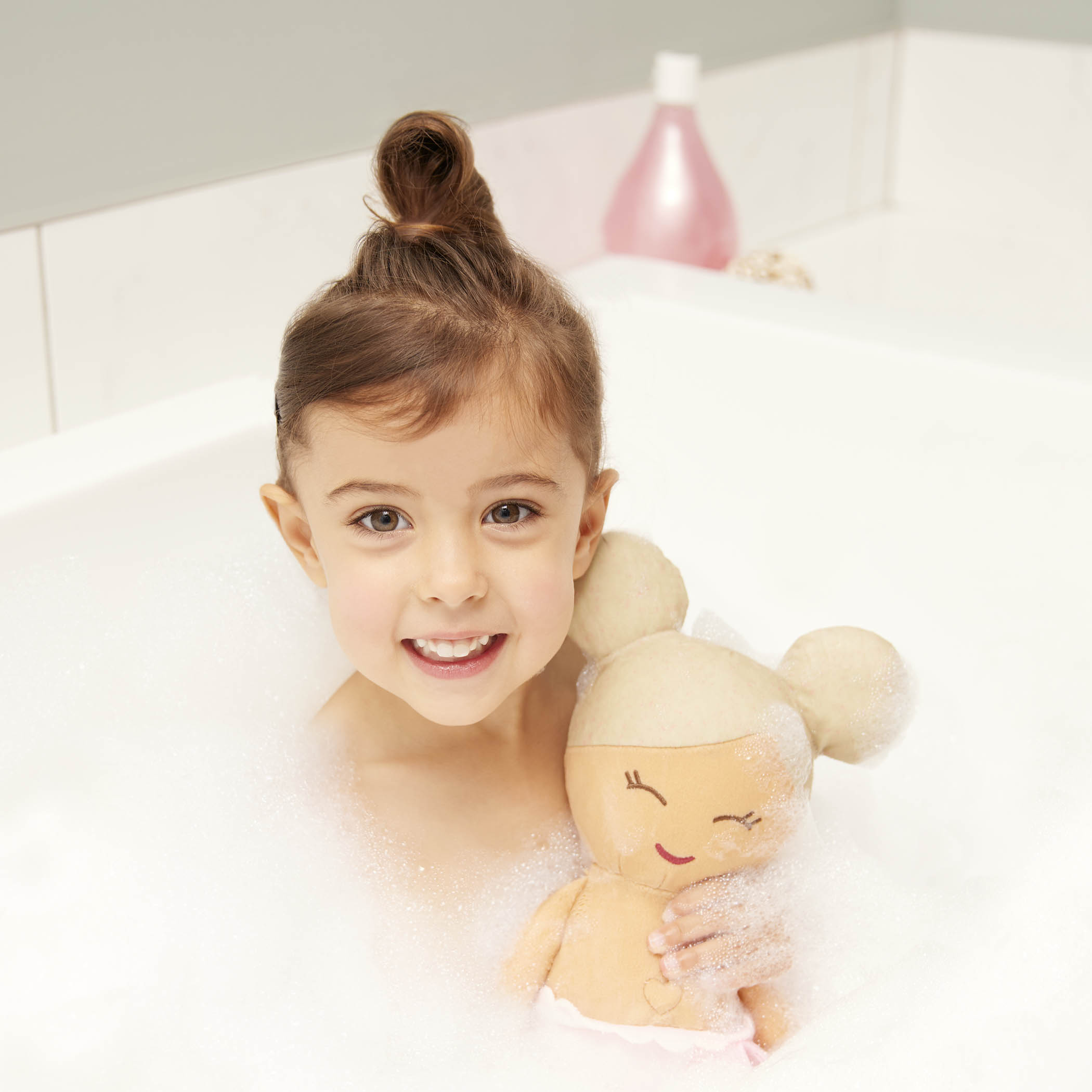 girl in bath with LullaBaby bath doll