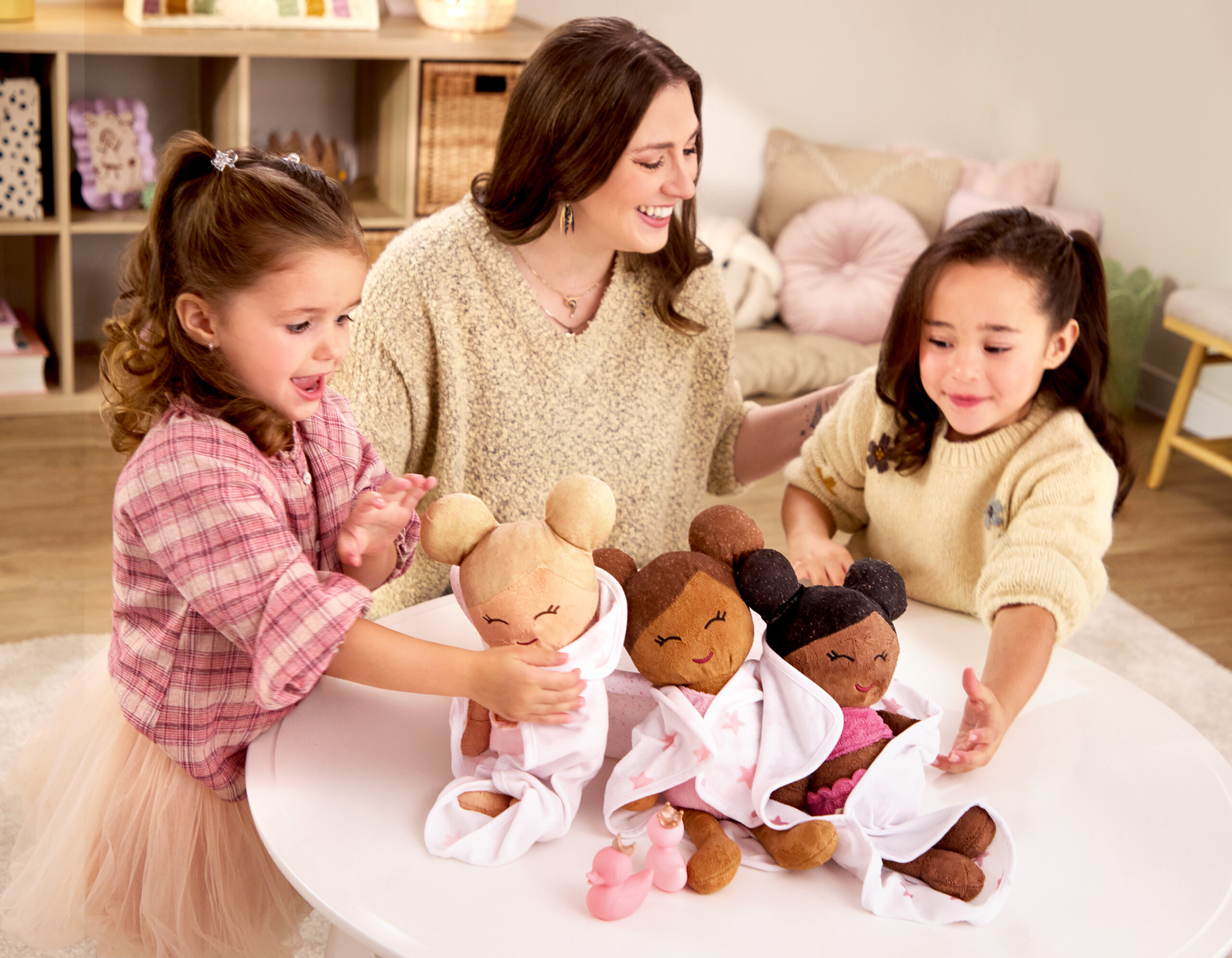 mom with young girls and lullababy bath dolls