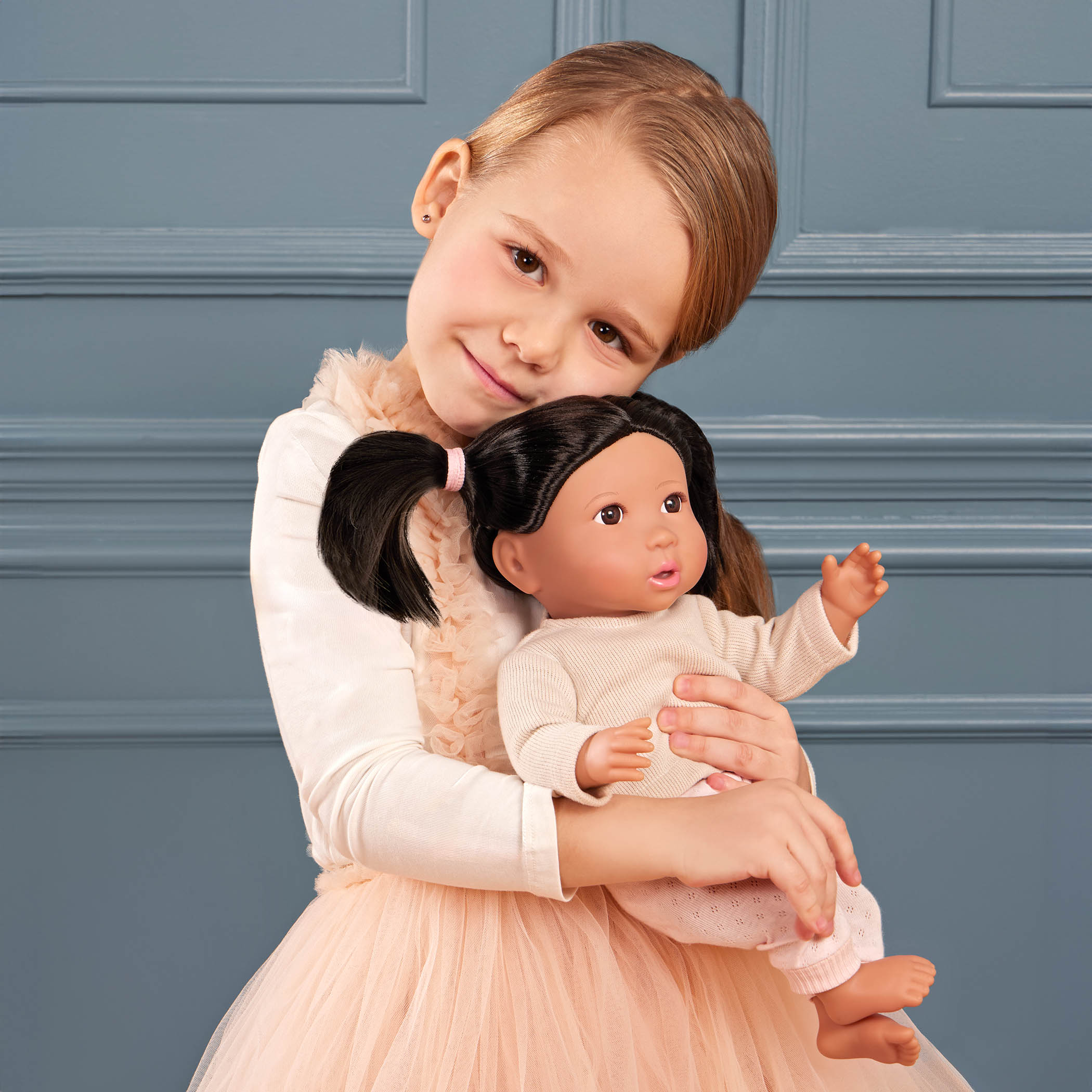 girl with lullababy doll with black hair