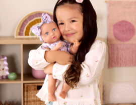 girl with floral lullababy doll