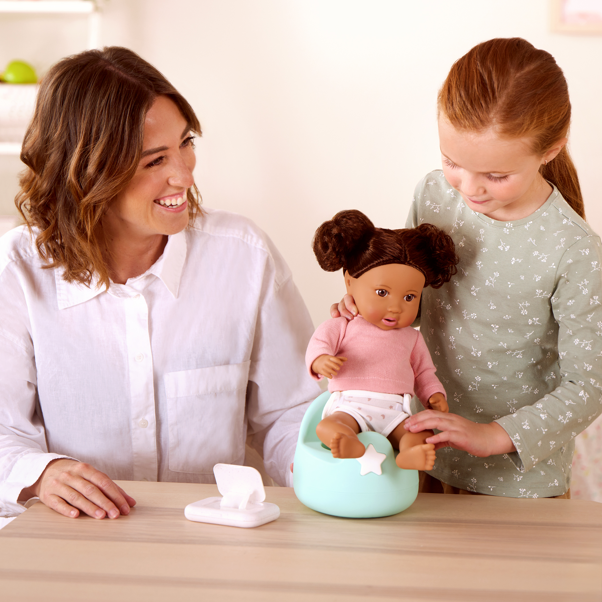 Mother and daughter playing with LullaBaby doll and potty