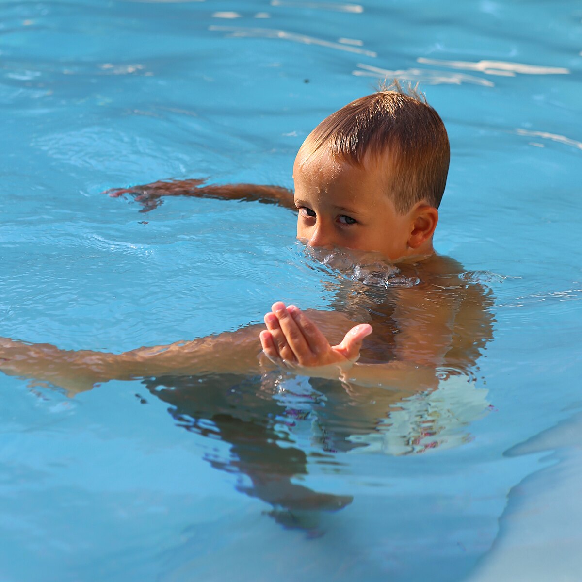 boy blowing bubbles
